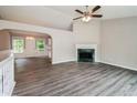Bright living room with hardwood floors, a ceiling fan, and a fireplace at 75 Willow Bend Nw Dr, Cartersville, GA 30121