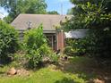 Home exterior with red brick and lots of greenery at 1526 Snapfinger Rd, Decatur, GA 30032