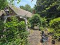 Side yard shows brick details, plants, and an outdoor seating area at 1526 Snapfinger Rd, Decatur, GA 30032