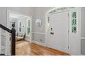 Inviting foyer featuring a white front door, hardwood floors, and natural light at 4754 Township Chase, Marietta, GA 30066