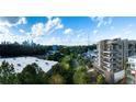 Apartment building with balconies overlooking a lush green space with a city skyline in the background at 675 Drewry Ne St # 205, Atlanta, GA 30306