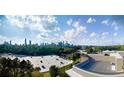 Exterior shot of rooftop overlooking Atlanta skyline with lush trees and blue skies at 675 Drewry Ne St # 205, Atlanta, GA 30306