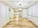 Dining area features a stylish light fixture, hardwood floors and is open to the kitchen and living room at 6700 Roswell Rd # 11B, Atlanta, GA 30328