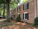 Brick exterior of a multi-Gathering home with large windows and a well-maintained lawn and landscaping at 6700 Roswell Rd # 11B, Atlanta, GA 30328
