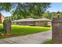 Beautiful brick and stone home with lush green lawn and mature trees at 1535 Pathfinder Sw Way, Lilburn, GA 30047