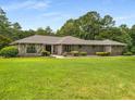 Attractive brick and stone home with a well-maintained lawn and mature trees at 1535 Pathfinder Sw Way, Lilburn, GA 30047