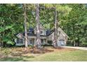 Charming home with a well-manicured lawn and lush greenery, featuring a two-car garage and inviting front porch at 2130 Hampton Se Trl, Conyers, GA 30013