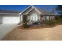 Inviting single story home with brick exterior, a patio set, manicured yard and an attached two car garage at 3311 Lindenridge Dr, Buford, GA 30519
