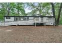 Lovely house with a white ramp leading to the entrance, complemented by a surrounding wooded area at 343 Compton Rd, Rockmart, GA 30153