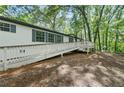 Exterior view with a ramp providing easy access, surrounded by a lush green forest setting at 343 Compton Rd, Rockmart, GA 30153