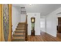 Grand foyer featuring hardwood floors, staircase, and a classic grandfather clock at 3906 Laurens Ln, Snellville, GA 30039