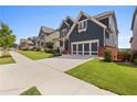 Charming two-story home featuring a well-manicured lawn and lush landscaping with blue siding and a two-car garage at 326 Still Pine Bnd, Smyrna, GA 30082