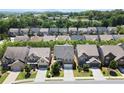 Beautiful aerial view of a residential neighborhood showcasing well-maintained homes, green trees, and manicured lawns at 4452 Thach Ave, Sugar Hill, GA 30518