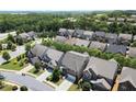 Scenic aerial shot of a neighborhood featuring lush trees, well-kept homes, and neatly landscaped yards on a sunny day at 4452 Thach Ave, Sugar Hill, GA 30518