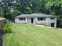 Attractive one-story home with a well-kept lawn, landscaped garden beds, and convenient garage access at 2926 Monterey Dr, Decatur, GA 30032