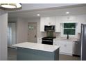 Bright kitchen featuring a modern island, stainless steel appliances, and stylish backsplash at 2926 Monterey Dr, Decatur, GA 30032