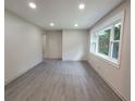 Bright living room features gray flooring, recessed lights, and a large window at 2926 Monterey Dr, Decatur, GA 30032