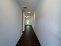 Bright hallway with sleek dark wood flooring, leading to a well-lit room at 1115 Lockhart Way, Douglasville, GA 30135