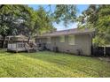 The backyard showcases a wooden deck, a well-maintained lawn, and mature trees, ideal for outdoor enjoyment at 2191 Greystone Way, Decatur, GA 30032