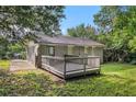 Backyard features a wooden deck and a spacious, green lawn perfect for outdoor activities at 2191 Greystone Way, Decatur, GA 30032