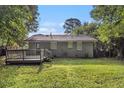 A view of a well-maintained backyard with a small wooden deck, offering ample space for outdoor relaxation at 2191 Greystone Way, Decatur, GA 30032