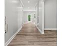 Bright hallway showcasing modern flooring and neutral paint, leading to various rooms at 5341 Stewart Mill Rd, Douglasville, GA 30135