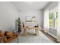 Well-lit home office with a modern desk, chair, and view from the window at 5341 Stewart Mill Rd, Douglasville, GA 30135