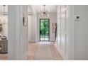 Bright foyer with hardwood floors, decorative lighting, and an elegant door with glass panes at 104 Trinity Hollow Dr, Canton, GA 30115