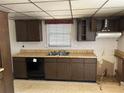 Traditional kitchen featuring wood cabinets, laminate countertops, double sink and appliances at 512 Rockborough Ter, Stone Mountain, GA 30083