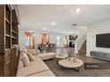Open-concept living room and dining area with modern furnishings and ample natural light at 1363 Midnight Ride Ct, Hampton, GA 30228