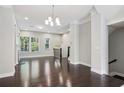 Open-concept living room with ample space, large windows, and access to an upstairs staircase at 1829 Hislop Ln, Atlanta, GA 30345