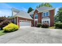 Lovely brick home with attached garage and manicured front yard landscaping at 3820 Ridge Point Dr, Suwanee, GA 30024