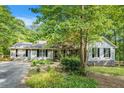 Daytime exterior view of a single-Gathering home with gray siding, black shutters, and mature landscaping at 675 Mayes, Powder Springs, GA 30127