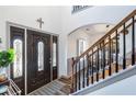 Bright foyer featuring a decorative front door with leaded glass sidelights and an open staircase to the upper level at 949 Tumlin Trce, Lawrenceville, GA 30045