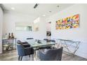 Bright dining room featuring modern decor with a large glass table and a large mirror at 3222 Long Creek Dr, Buford, GA 30519