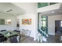 Bright dining room featuring modern decor, a glass table, and a glass staircase at 3222 Long Creek Dr, Buford, GA 30519