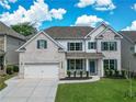 Charming two-story home with a well-manicured lawn and a classic white brick facade at 3222 Long Creek Dr, Buford, GA 30519