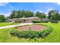 Well-manicured front yard of a charming brick home featuring tidy landscaping at 3405 Leisure Ln, Atlanta, GA 30349