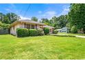 Charming brick home with well-maintained landscaping and a spacious front yard at 3405 Leisure Ln, Atlanta, GA 30349