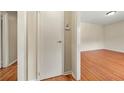 Clean hallway with wood floors and a closet leading to other rooms in the home at 3405 Leisure Ln, Atlanta, GA 30349