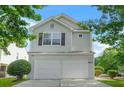 Two-story home with a two-car garage and mature landscaping at 3451 Carriage Chase Rd, Atlanta, GA 30349