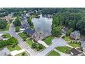 Stunning aerial view of neighborhood homes surrounding a tranquil lake with mature trees at 1375 Highland Lake Dr, Lawrenceville, GA 30045