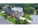 Gorgeous home overlooking a peaceful lake surrounded by lush trees and manicured lawns at 1375 Highland Lake Dr, Lawrenceville, GA 30045