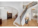 Bright foyer featuring hardwood floors, a staircase with iron railings and trim, and views to the dining room at 4715 Mcintosh Drive Dr, Cumming, GA 30040