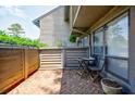 Inviting outdoor patio with brick flooring and a charming table with chairs at 1002 Creatwood Se Cir, Smyrna, GA 30080