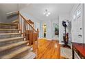 Entryway showcasing hardwood floors, staircase, and open access to other rooms in the home at 1809 Claron Ave, Conley, GA 30288