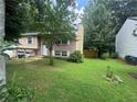 View of a split-level house with a well-maintained lawn and landscaping at , Roswell, GA 30076