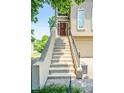 Inviting front entrance with staircase leading to a red front door and manicured landscaping at 2556 Oakwood Se Trce, Smyrna, GA 30080