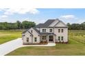 Beautifully designed two-story home with a manicured lawn on a sunny day at 3284 Hall Rd, Dacula, GA 30019