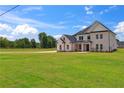 Charming two-story home with brick exterior and expansive green lawn at 3284 Hall Rd, Dacula, GA 30019